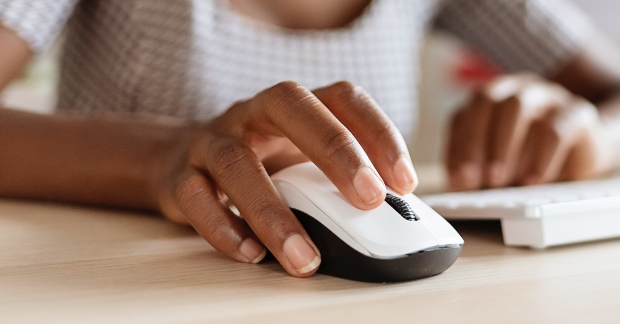 Person clicking on mouse