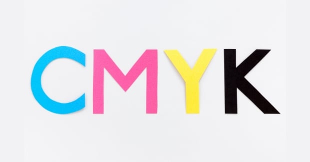 Paper cut out in the letters CMYK