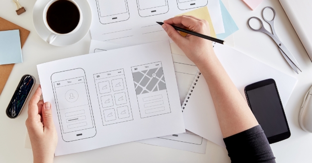Person going drawing UX wireframes 